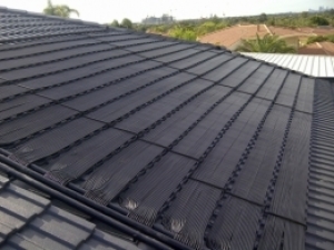 Solar pool matting collector installed on a tile_roof.jpg